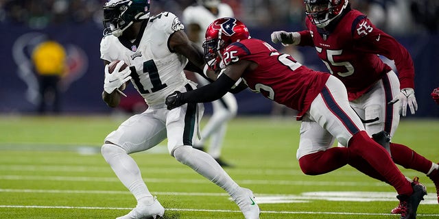 Philadelphia Eagles wide receiver A.J. Brown, #11, carries against Houston Texans cornerback Desmond King II, #25, in the second half of an NFL football game in Houston, Thursday, Nov. 3, 2022.