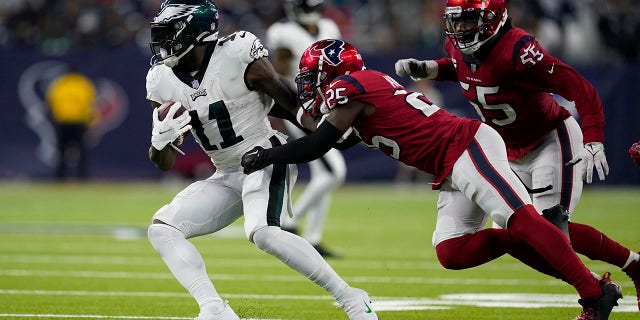 Philadelphia Eagles wide receiver A.J. Brown, #11, carries against Houston Texans cornerback Desmond King II, #25, in the second half of an NFL football game in Houston, Thursday, Nov. 3, 2022.