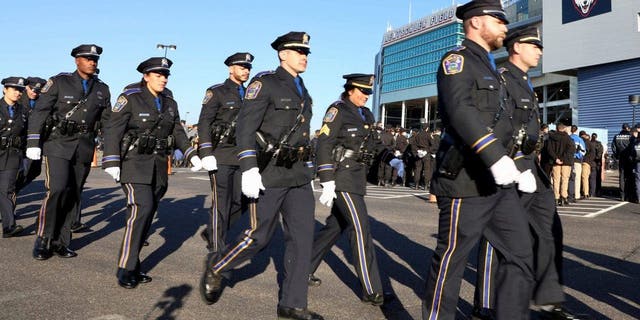 Police officers report to Pratt &  Whitney Stadium at Rentschler Field for a funeral service for Bristol police officers Dustin DeMonte and Alex Hamzy, Friday, October 21, 2022, in East Hartford, Conn. 