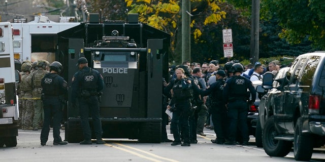 Law enforcement personnel gather at the scene where two officers were reported shot, Tuesday, Nov. 1, 2022, in Newark, New Jersey.  