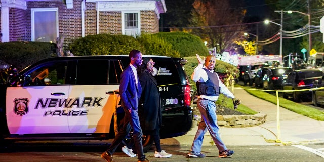 Newark Mayor Ras Baraka, right, arrives to the scene where two police officers were reported shot, Tuesday, Nov. 1, 2022, in Newark, New Jersey.