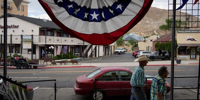 People walk along the main drag in the county seat of Nye County July 18, 2022, in Tonopah, Nevada.