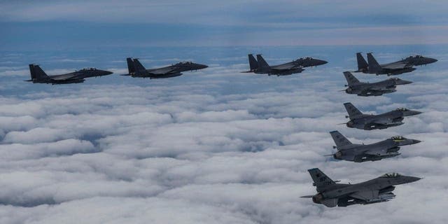 South Korean Air Force's F15K fighter jets and U.S. Air Force's F-16 fighter jets, fly in formation during a joint drill in an undisclosed location in South Korea, Oct. 4, 2022. 