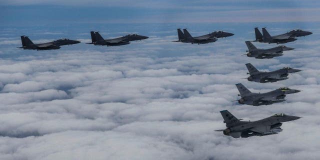 South Korean Air Force F15K fighters and U.S. Air Force F-16s fly in formation during a joint exercise at an unknown location in South Korea, October 4, 2022. 