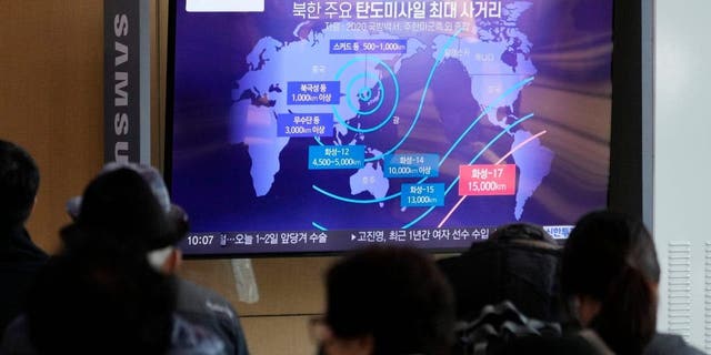 A television screen showing a news program reporting North Korean missile launches at Seoul, South Korea railway station on November 4, 2022. The sign reads "North Korea's main range of ballistic missiles." 