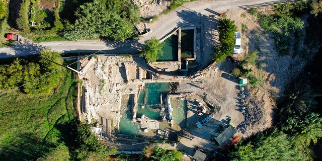 Archaeologists work at the site of the discovery of two dozen well-preserved bronze statues from an ancient Tuscan thermal spring in San Casciano dei Bagni, central Italy, in this update photo made available by the Italian Culture Ministry, Friday, Sept. 23, 2022.