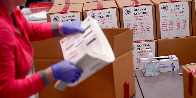 An election worker boxes tabulated ballots inside the Maricopa County Recorders Office, Wednesday, Nov. 9, 2022, in Phoenix. 