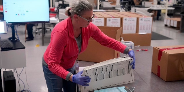 An election worker boxes tabulated ballots inside the Maricopa County Recorder's Office Nov. 9, 2022, in Phoenix.