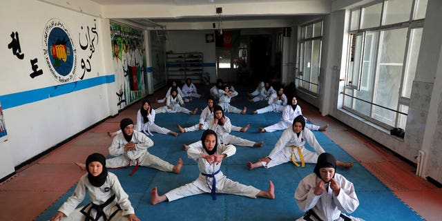 FILE, Female Afghan Taekwondo team members practice during a training session in Kabul, Afghanistan, Monday, March 1, 2021. The Taliban are banning women from using gyms in Afghanistan, an official in Kabul said Thursday, Nov. 10, 2022, the religious group's latest edict cracking down on women's rights and freedoms since they took power more than a year ago. 