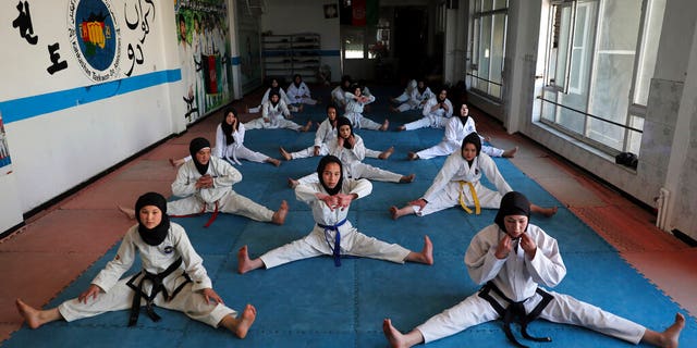 FILE, Female Afghan Taekwondo team members practice during a training session in Kabul, Afghanistan, Monday, March 1, 2021. The Taliban are banning women from using gyms in Afghanistan, an official in Kabul said Thursday, Nov. 10, 2022, the religious group's latest edict cracking down on women's rights and freedoms since they took power more than a year ago. 