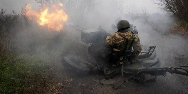 Ukrainian National Guard soldiers fire at Russian positions from an anti-aircraft gun in Kharkiv region, Ukraine, Friday, November 11, 2022. 