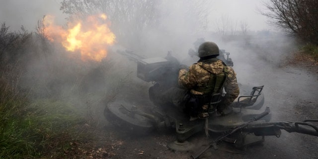 Ukrainian National guard soldiers fire at Russian positions from an anti-aircraft gun in Kharkiv region, Ukraine, Friday, Nov. 11, 2022. 