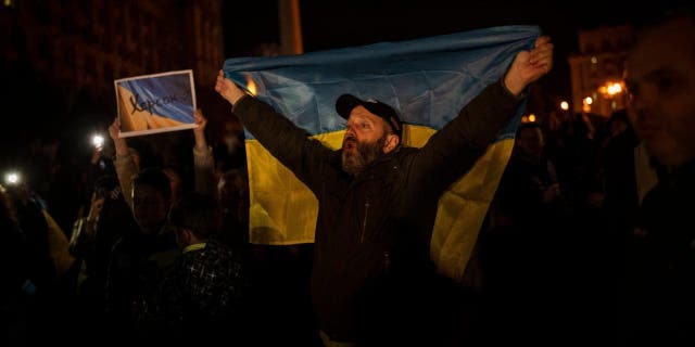 Ukrainians gather in central Kyiv to celebrate the recapturing of Kherson city, Ukraine, Friday, Nov. 11, 2022. 