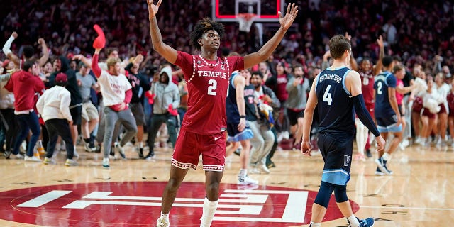 Temple's Jahlil White, left, celebrates past Villanova's Chris Arcidiacono after Temple won an NCAA college basketball game, Friday, Nov. 11, 2022, in Philadelphia.