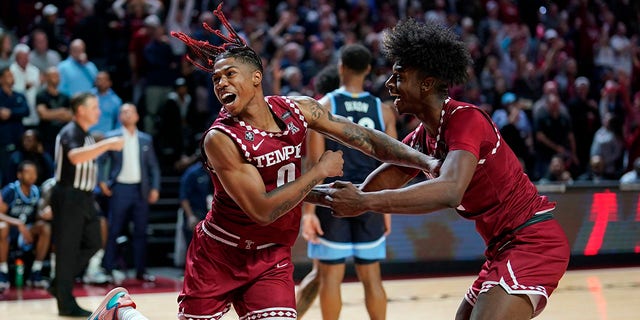 Temple's Khalif Battle, left, and Jahlil White celebrate during the final second of an NCAA college basketball game against Villanova, Friday, Nov. 11, 2022, in Philadelphia.