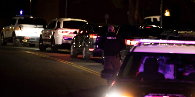 A police officer walks up Culbreath Road during an active shooter situation on the University of Virginia campus in Charlottesville, Va., on Monday, Nov. 14, 2022.