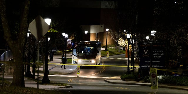 A bus idles behind police tape during an active shooter situation at the University of Virginia in Charlottesville on Monday, Nov. 14, 2022.