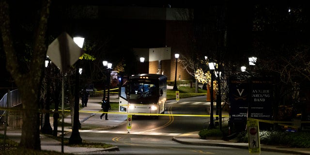 A bus idles behind police tape during an active shooter situation at the University of Virginia in Charlottesville on Monday.