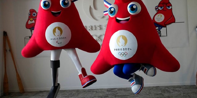 The mascots of the Paris 2024 Olympic Games, right, and the Paralympic Games, a Phrygian cap, jump during a preview in Saint Denis, outside Paris.  The soft bright red cap, also known as the liberty cap, is an updated version of a conical hat worn in ancient times in places such as Persia, the Balkans, Thrace, Dacia and Phrygia, where the name originates from, in present-day Turkey.