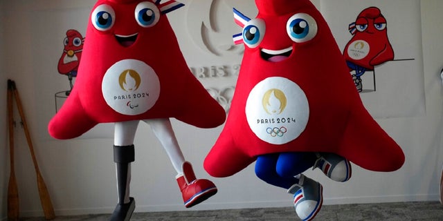 The mascots of the Paris 2024 Olympic Games, right, and the Paralympic Games, a Phrygian cap, jump during a preview in Saint Denis, outside Paris.  The soft bright red cap, also known as the liberty cap, is an updated version of a conical hat worn in ancient times in places such as Persia, the Balkans, Thrace, Dacia and Phrygia, where the name originates from, in present-day Turkey.