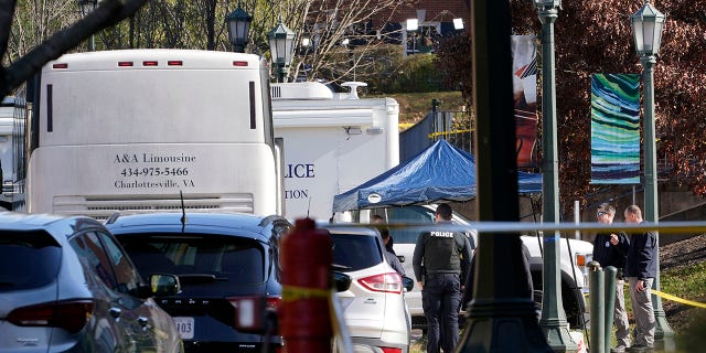 Police investigators work around a bus which is believed to be the site of an overnight shooting on the grounds of the University of Virginia in Charlottesville on Monday.