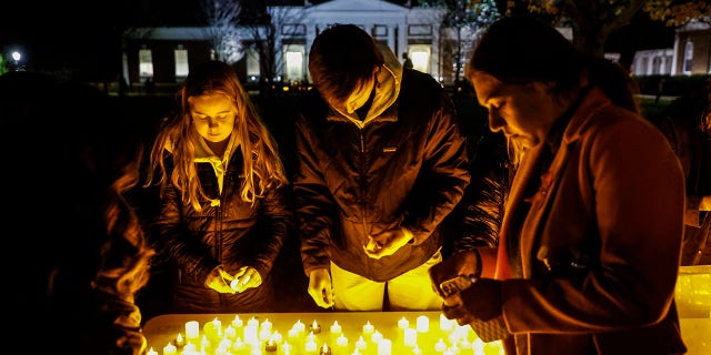 Students and community members gather for a candlelight vigil after a shooting that left three students dead at the University of Virginia in Charlottesville.