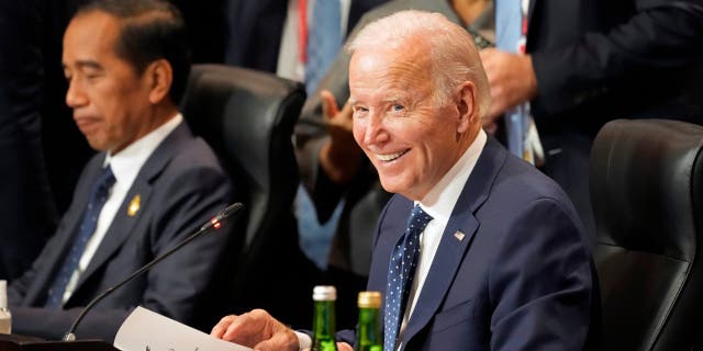 Sitting next to Indonesian President Joao Widodo, President Biden smiles during the Partnership for Global Infrastructure and Investment meeting at the G20 summit, Tuesday, Nov. 15, 2022, in Nusa Dua, Bali, Indonesia.