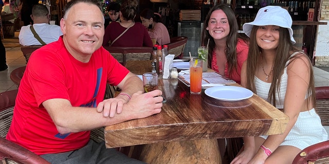 This Dec. 2021 photo provided by Jazzmin Kernodle shows father Jeff Kernodle, left, Xana, middle, and Jazzmin, in Puerto Vallarta, Mexico. 