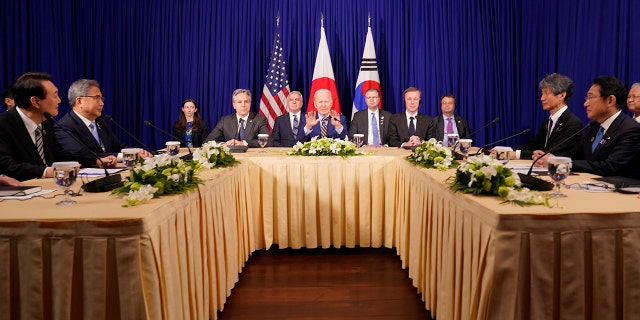 U.S. President Joe Biden meets with South Korean President Yoon Suk Yeol, left, and Japanese Prime Minister Fumio Kishida, right, on the sidelines of the Association of Southeast Asian Nations (ASEAN) summit on Nov. 13, 2022, in Phnom Penh, Cambodia. 