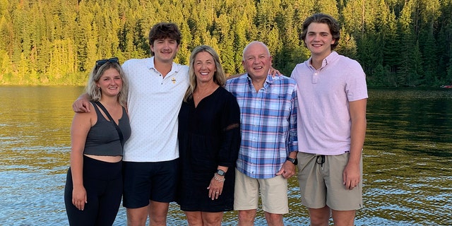 In this photo provided by Stacy Chapin, triplets Maizie, left, Ethan, second from left, and Hunter, right, pose with their parents Stacy and Jim Chapin at Priest Lake in northern Idaho in July 2022. Ethan Chapin was one of four University of Idaho students found stabbed to death in a home near the Moscow, Idaho campus on Sunday, Nov. 13, 2022. Police are still searching for a suspect in the case.