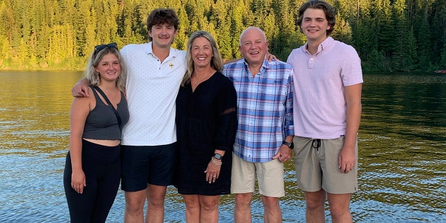 In this photo provided by Stacy Chapin, triplets Maizie, left, Ethan, second from left, and Hunter, right, pose with their parents Stacy and Jim Chapin at Priest Lake in northern Idaho in July 2022. Ethan Chapin was one of four University of Idaho students found stabbed to death in a home near the Moscow, Idaho campus on Sunday, Nov. 13, 2022. Police are still searching for a suspect in the case.