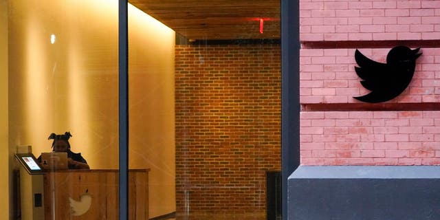 A receptionist works in the lobby of the building that houses the Twitter office in New York, Wednesday, Oct. 26, 2022.