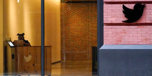 A receptionist works in the lobby of the building that houses the Twitter office in New York, Wednesday, Oct. 26, 2022.