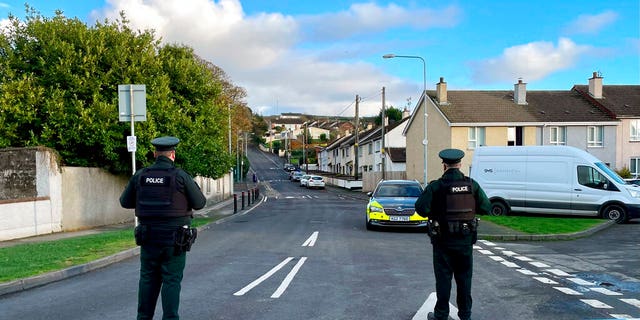 Officers from the Police Service of Northern Ireland (PSNI) stand guard at the scene, following the attempted murder of two officers in Strabane, Northern Ireland, Friday Nov. 18, 2022. 