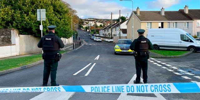 Officers from the Police Service of Northern Ireland (PSNI) stand guard at the scene, following the attempted murder of two officers in Strabane, Northern Ireland, Friday Nov. 18, 2022.