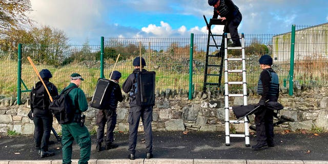 Army search teams assisted by the PSNI inspect the scene, following the attempted murder of two officers in Strabane, Northern Ireland, Friday Nov. 18, 2022. 