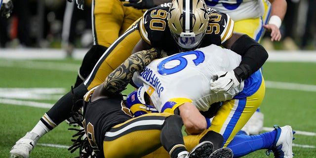 Los Angeles Rams quarterback Matthew Stafford (9) is sacked by New Orleans Saints defensive end Tanoh Kpassagnon (90) in the second half of an NFL football game in New Orleans, Sunday, Nov. 20, 2022.