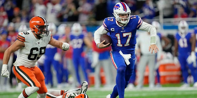 Buffalo Bills quarterback Josh Allen (17) scrambles past Cleveland Browns defensive end Chase Winovich (69) and safety Ronnie Harrison Jr. (33) during the second half of an NFL football game, Sunday, Nov. 20, 2022, in Detroit. 