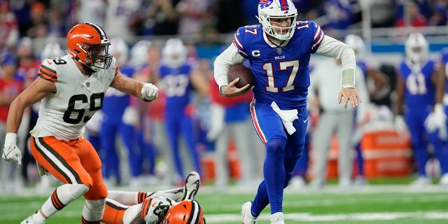 Buffalo Bills quarterback Josh Allen (17) scrambles past Cleveland Browns defensive end Chase Winovich (69) and safety Ronnie Harrison Jr. (33) during the second half of an NFL football game, Sunday, Nov. 20, 2022, in Detroit.