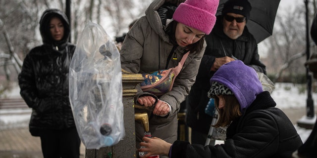 People collect water, Kyiv, Ukraine, Thursday, November 24, 2022. 