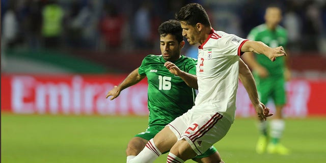 Voria Ghafouri, then a player of Iran national soccer team, right, fights for the ball with Iraqi midfielder Hussein Ali during their AFC Asian Cup soccer match at Al Maktoum Stadium in Dubai, United Arab Emirates, January 16, 2019. The semi-official Fars and news agencies Tasnim reported on Thursday, November 24, 2022 that Iran had arrested Ghafouri, a prominent former member of its national soccer team, for insulting the national soccer team currently playing at the World Cup and as criticizing the government Authorities are grappling with nationwide protests.