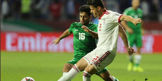 Voria Ghafouri, then a player of Iran national soccer team, right, fights for the ball with Iraqi midfielder Hussein Ali during their AFC Asian Cup soccer match at Al Maktoum Stadium in Dubai, United Arab Emirates, January 16, 2019. The semi-official Fars and news agencies Tasnim reported on Thursday, November 24, 2022 that Iran had arrested Ghafouri, a prominent former member of its national soccer team, for insulting the national soccer team currently playing at the World Cup and as criticizing the government Authorities are grappling with nationwide protests.
