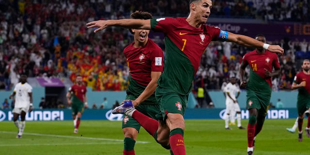 Portugal's Cristiano Ronaldo celebrates after scoring from the penalty spot his side's opening goal against Ghana during a World Cup Group H soccer match at the Stadium 974 in Doha, Qatar, Thursday, Nov. 24, 2022. 