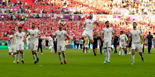 Iran's players celebrate winning the World Cup Group B soccer match against Wales at the Ahmad Bin Ali Stadium in Al Rayyan, Qatar, Friday, November 25, 2022. 