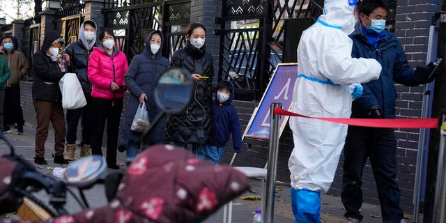 Residents line up for COVID-19 tests in Beijing, Saturday, Nov. 26, 2022. 