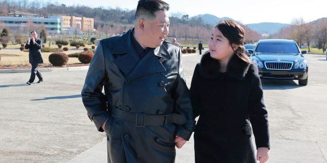 This undated photo provided on Nov. 27, 2022, by the North Korean government shows North Korean leader Kim Jong Un, left, and his daughter, right, walk to a photo session with those involved in the recent launch of what it says a Hwasong-17 intercontinental ballistic missile, at an unidentified location in North Korea.