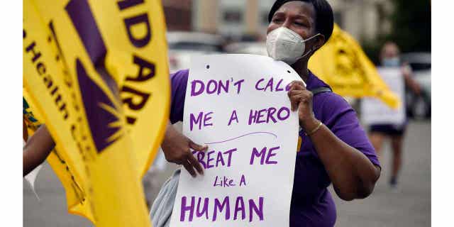 Clarissa Johnson marches with long-term care members of the New England Health Care Employees Union during a rally to demand new laws to protect long-term caregivers and consumers, on July 23, 2020, in Hartford, Connecticut.