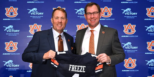 Auburn football coach Hugh Freeze (left) and athletic director John Cohen pose at a news conference in Auburn, Alabama on Tuesday, November 29, 2022.