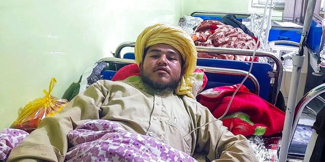 A wounded man receives treatment at a hospital after a deadly bomb blast at a religious school in Aybak, the capital of the Samangan province in northern Afghanistan, Wednesday, Nov. 30, 2022. The blast Wednesday at a madrassa killed at least 10 and wounded a number of students, a Taliban official said.