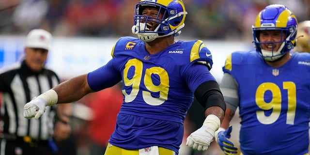 Los Angeles Rams defensive tackle Aaron Donald (99) celebrates after a sack as defensive tackle Greg Gaines watches during the first half of a game against the San Francisco 49ers Oct. 30, 2022, in Inglewood, Calif. 